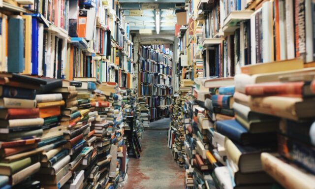 Pathway in the middle of piled books. Original public domain image from Wikimedia Commons